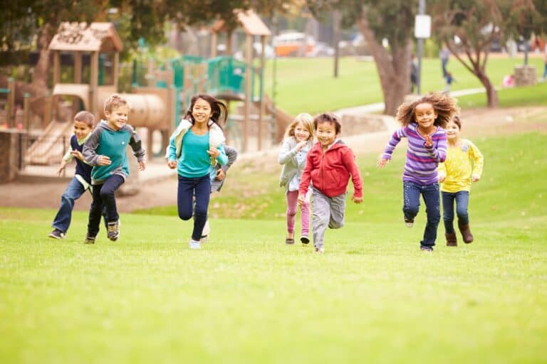 many children of different races running & playing together