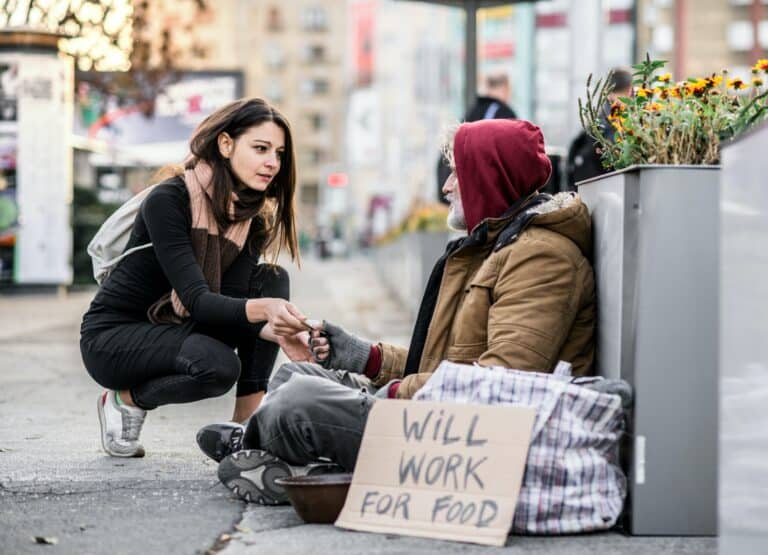 woman gives homeless man money feels good