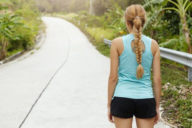 jogging woman with willpower determination viewing road ahead