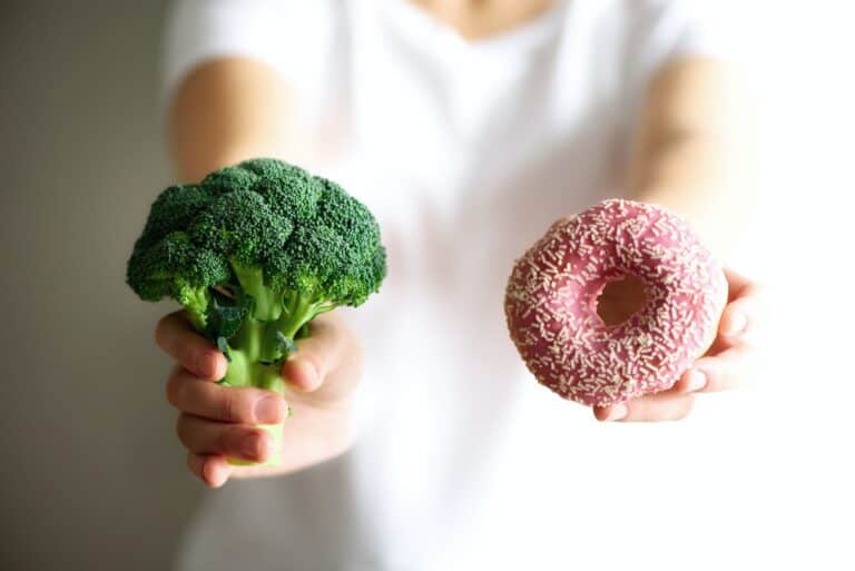 person holding broccoli or donut willpower and determination