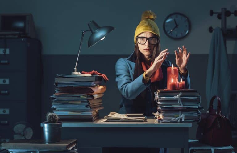 Woman wearing a jacket and yellow hat at work with no heat feeling the ups and downs of life