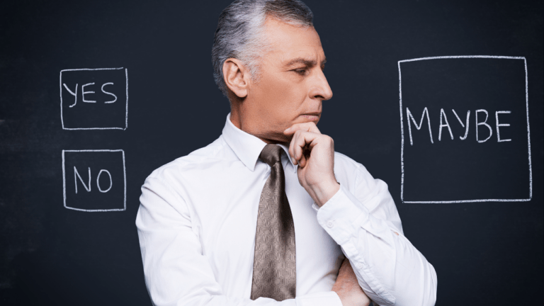 man in front of blackboard trying to make a decision