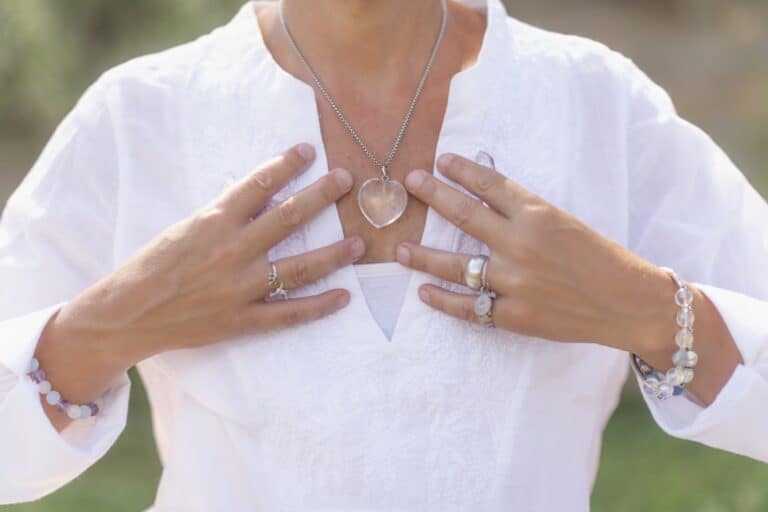 woman with both hands over chest being grateful