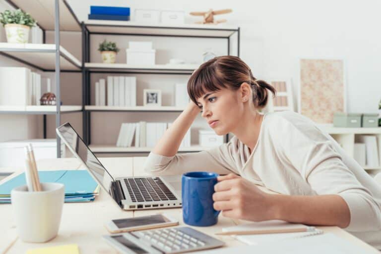 woman at laptop feeling a lack of inspiration