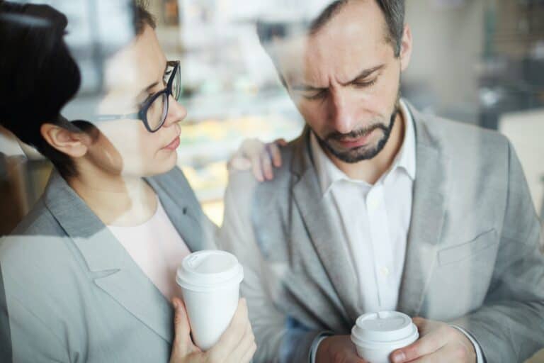 woman and man having coffee and she being empathetic