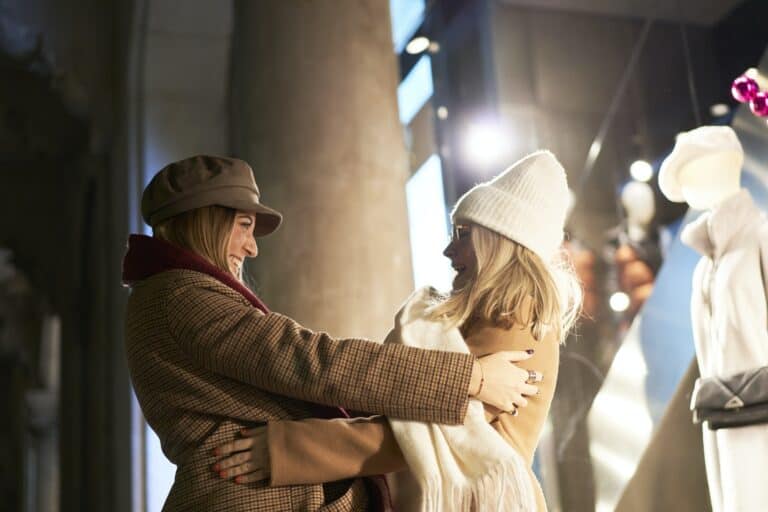 Two girls that are old friends greeting each other with a hug.