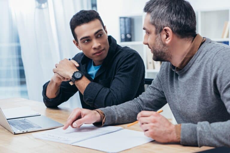 Man showing coworker how to work smarter